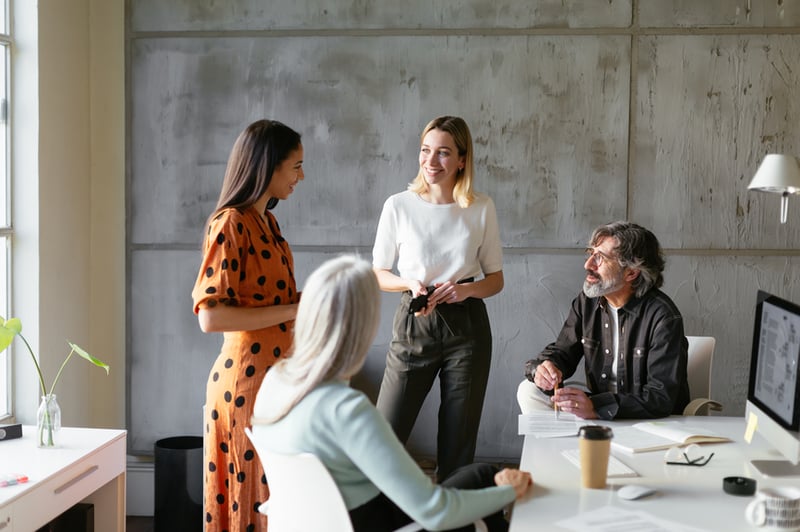 group-of-four-people-smiling-at-work-growth-mindset