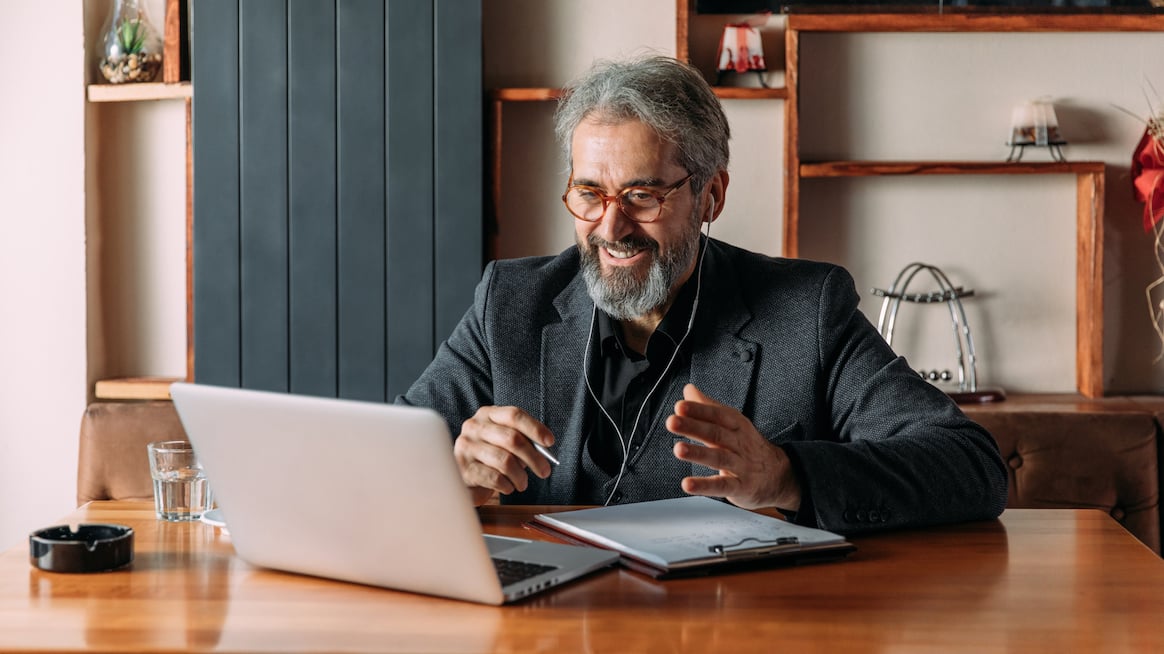 virtual-coaching-person-takes-call-on-a-laptop